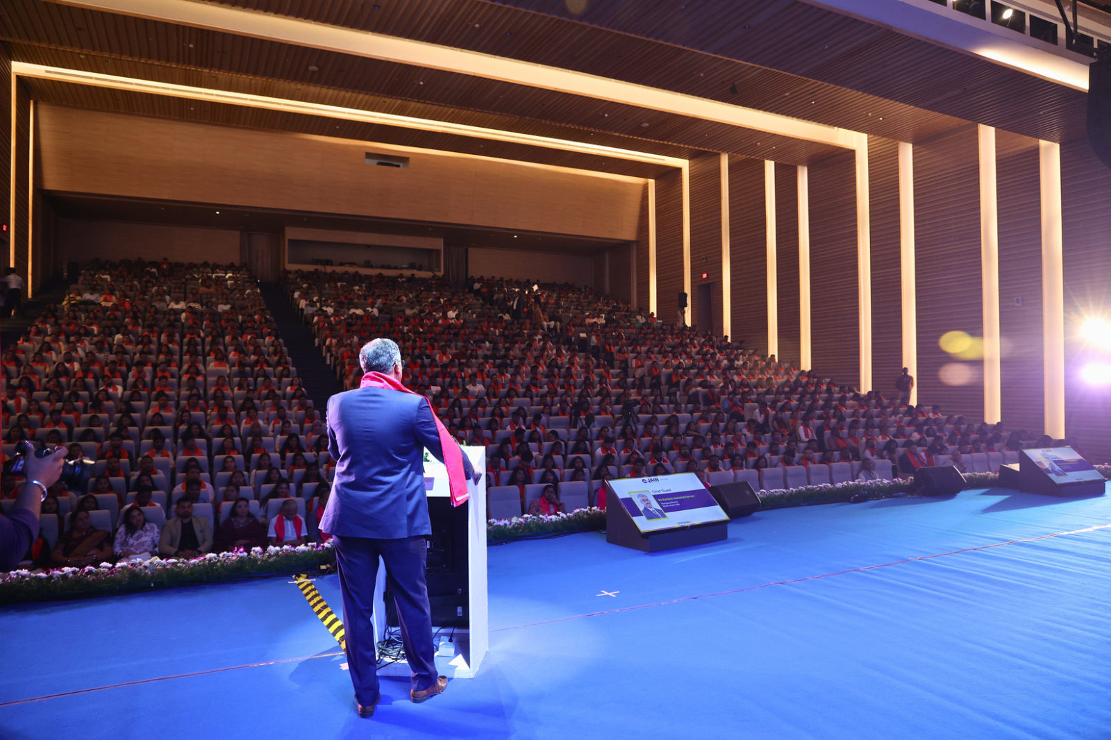 A speaker addressing the auditorium