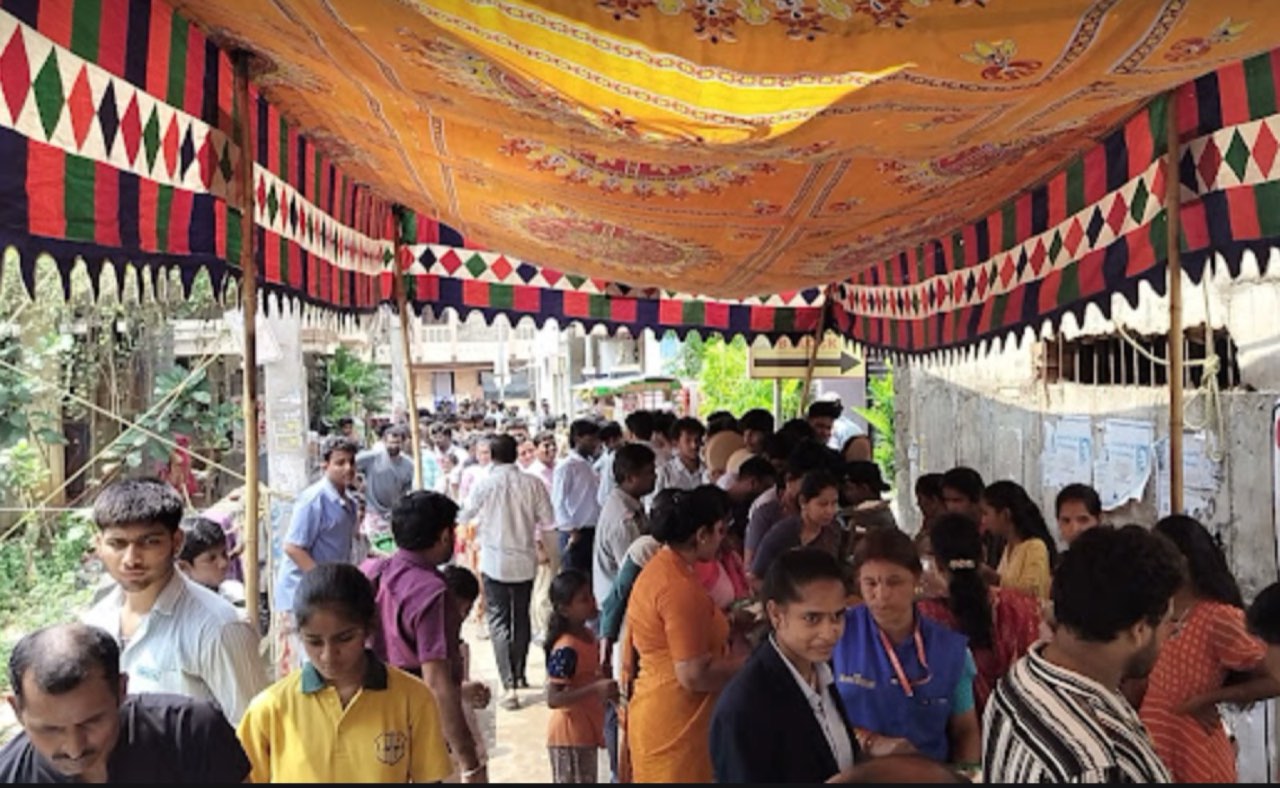 People gathered under the shamiana for Annadanam