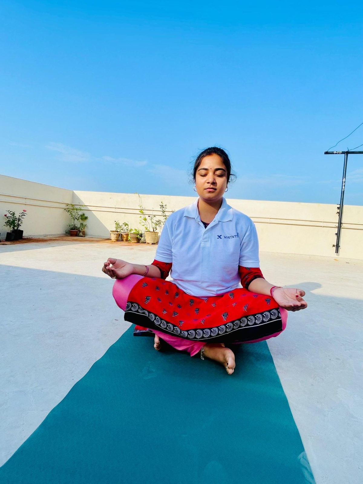 Our Director & Co-Founder in a seated yoga pose